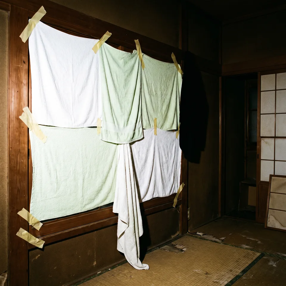 Towels hung across the window beside a microphone stand.
